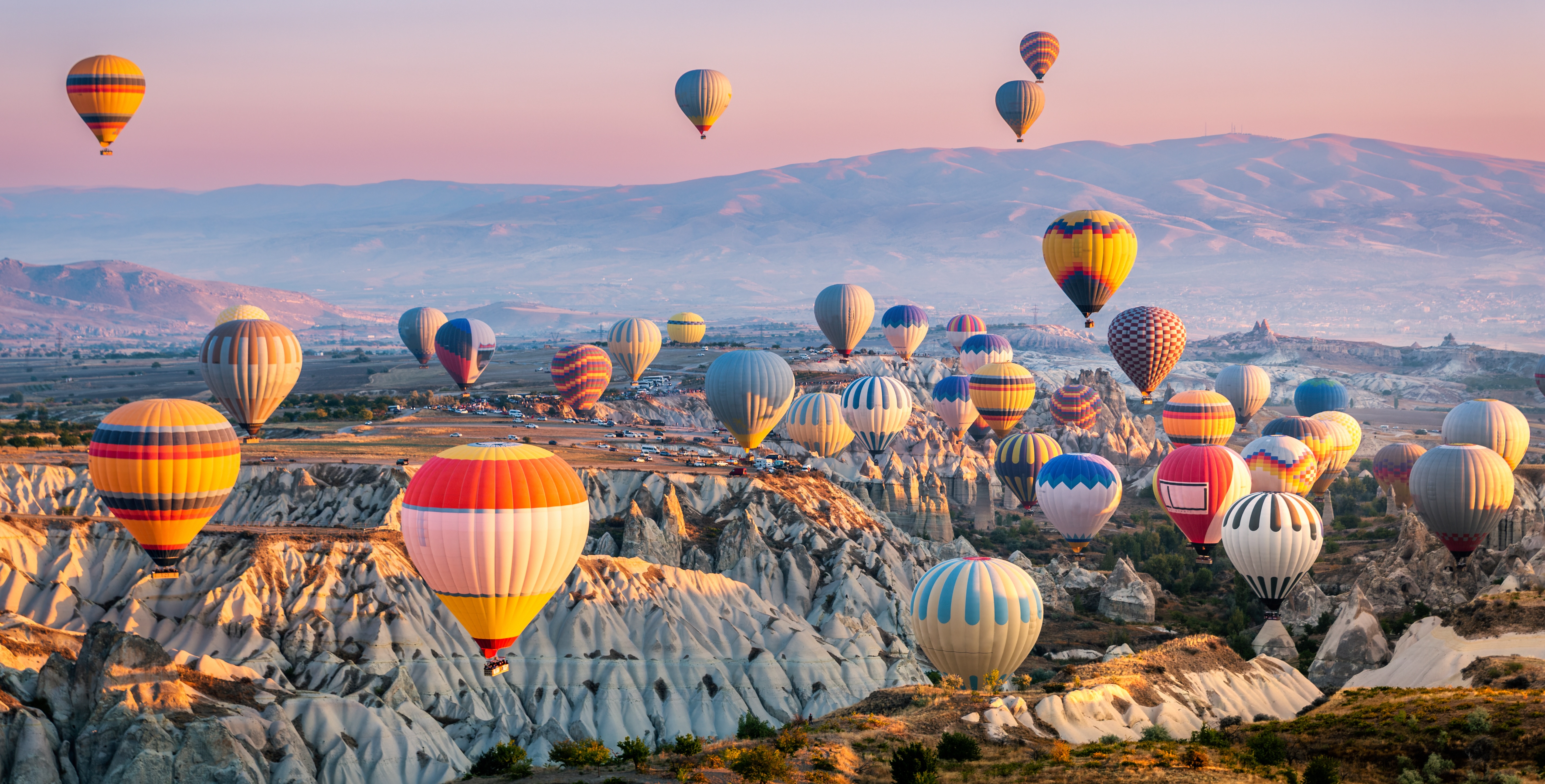 Hot air balloons over Göreme at sunrise, Cappadocia — Kısmet Travel